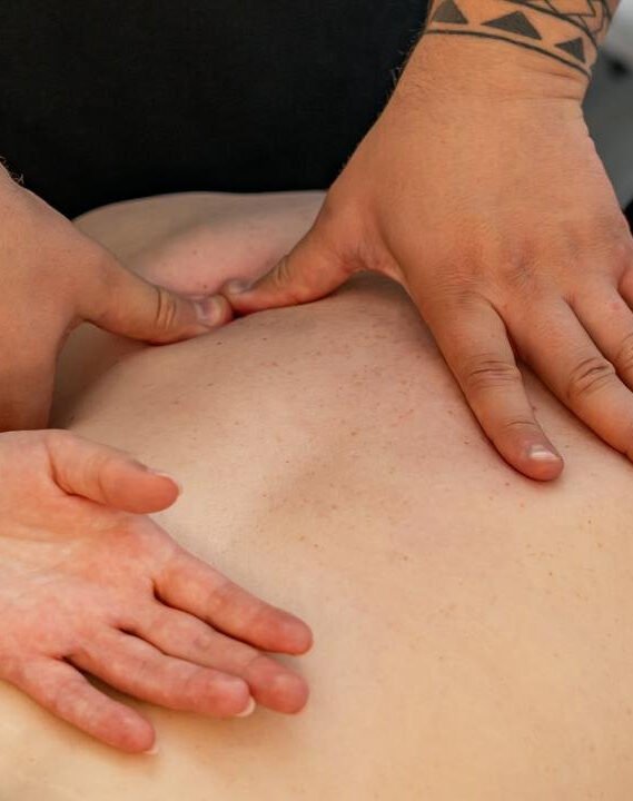 Massage therapist working on a client's back at ERA Massage & Beauty